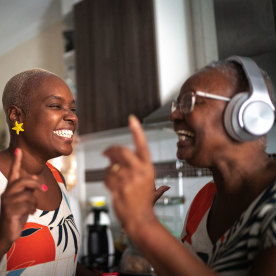 Mother and daughter dancing at home