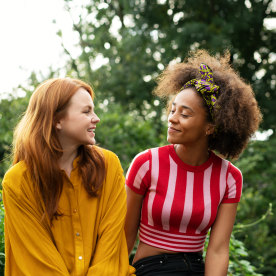 Two women sat on wall